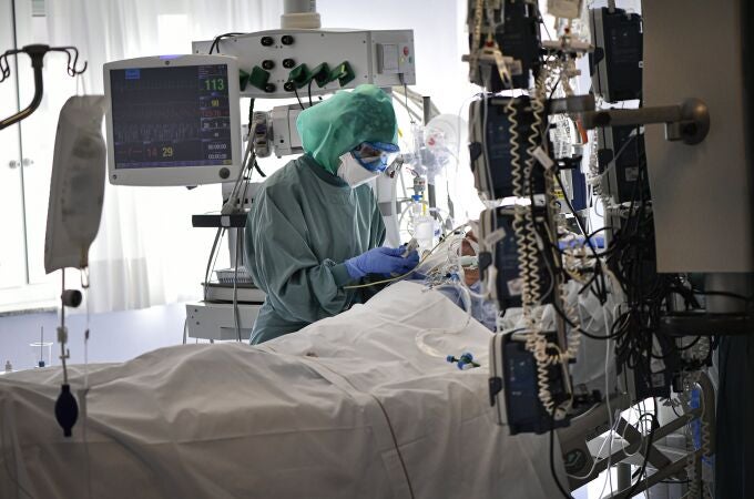 A medical staff member tends to a COVID-19 patient in the ICU department of the Clinica Universitaria, in Pamplona, northern Spain.