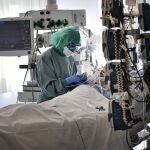 A medical staff member tends to a COVID-19 patient in the ICU department of the Clinica Universitaria, in Pamplona, northern Spain.