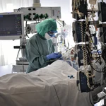 A medical staff member tends to a COVID-19 patient in the ICU department of the Clinica Universitaria, in Pamplona, northern Spain.