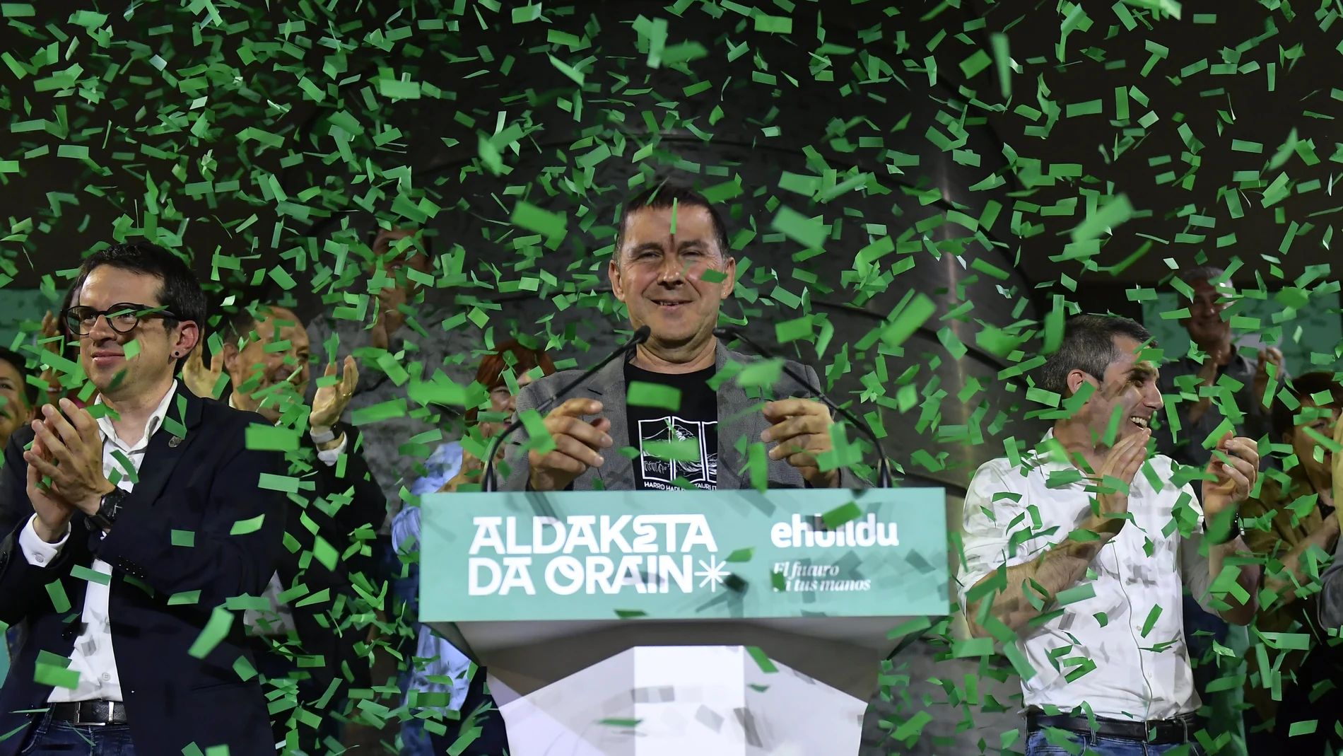 Basque EH-Bildu party General Secretary Arnaldo Otegi, centre and Pello Otxandiano, left, the candidate for EH-Bildu celebrate election results during the Basque regional elections in Bilbao, Spain, Sunday, April 21, 2024.