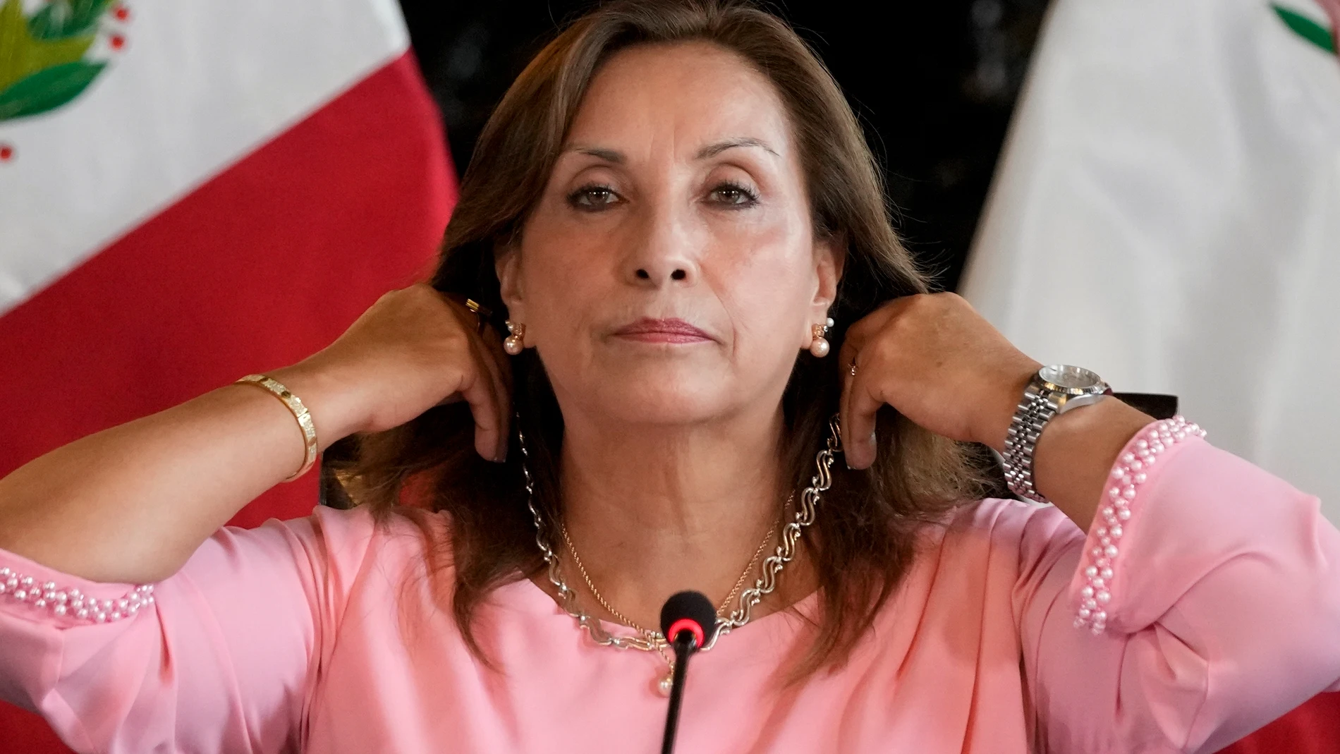 FILE - Peru's President Dina Boluarte shows her jewelry during a press conference at Government Palace in Lima, Peru, April 5, 2024. Authorities are investigating on whether she illegally received hundreds of thousands of dollars in cash, luxury watches and jewelry. (AP Photo/Martin Mejia, File)