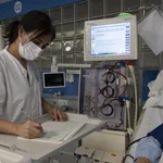 Una sanitaria del Hospital Clínic de Barcelona trabaja tomando notas a mano después de un ciberataque "complejo" sufrido, perpetrado desde fuera de España.