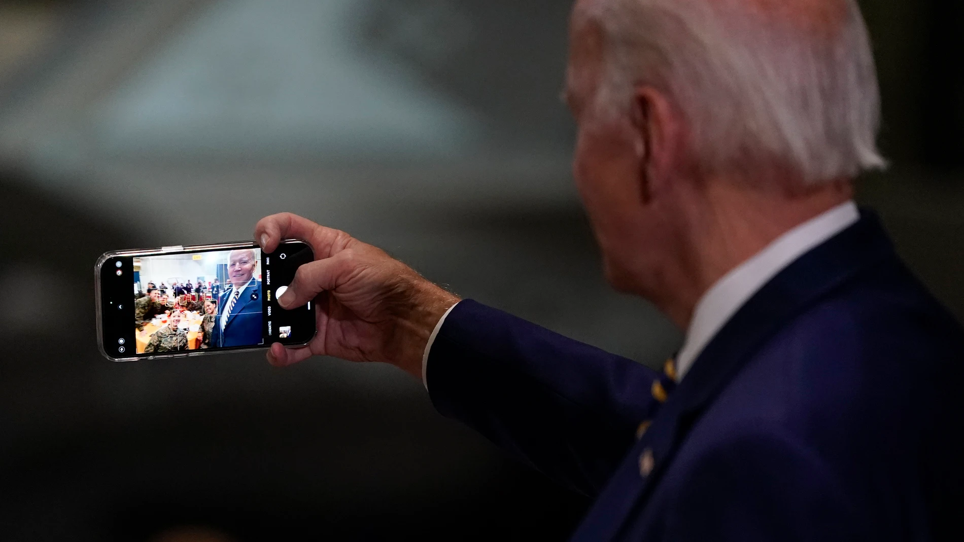 FILE - President Joe Biden takes a selfie at Marine Corps Air Station Cherry Point in Havelock, N.C., Monday, Nov. 21, 2022, at a Thanksgiving dinner with members of the military and their families. Democrats are wrestling with how to deploy generative AI. Still smarting from being outmaneuvered on social media by Donald Trump and his allies in 2016, Democratic strategists say they are nevertheless treading carefully in embracing artificial intelligence tool that disinformation experts say co...