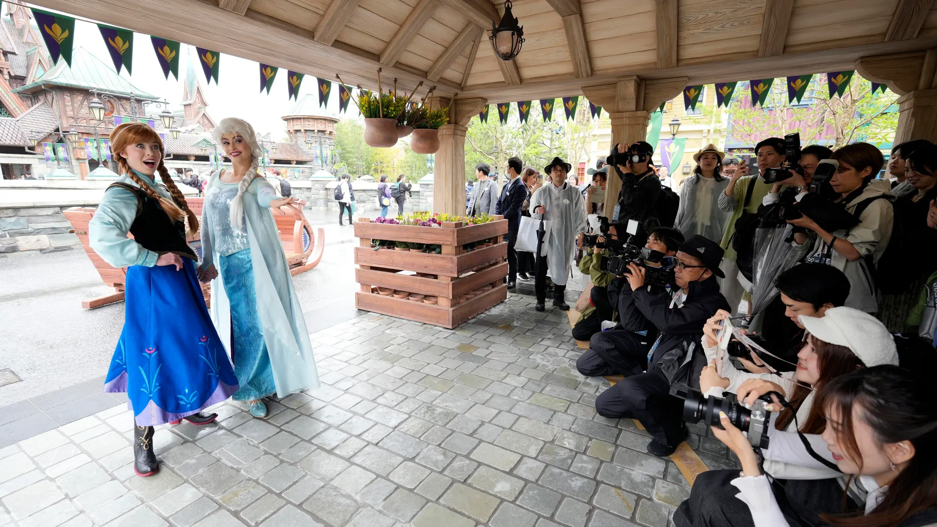 Urayasu (Japan), 07/05/2024.- Media members take pictures of performers impersonating Frozen'Äôs Anna (L) and Elsa (2-L) at Fantasy Springs, Tokyo DisneySea'Äôs new area, during its press preview at Tokyo DisneySea in Urayasu, near Tokyo, Japan, 07 May 2024. Fantasy Springs, which also features restaurants and a hotel, will open to the public on 06 June 2024. The new area is divided into three parts inspired by the movies 'ÄòFrozen'Äô, 'Tangled', and 'ÄòPeter Pan'Äô. Oriental Land, the operat...