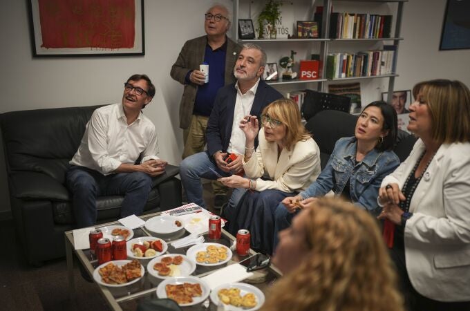 Socialist candidate Salvador Illa, left, watches early results on TV with other members of the PSC ( Socialist Party of Catalonia ) at the party headquarters in Barcelona, Sunday May 12, 2024. 