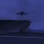 Imagen de un Harrier despegando del Juan Carlos I al anochecer