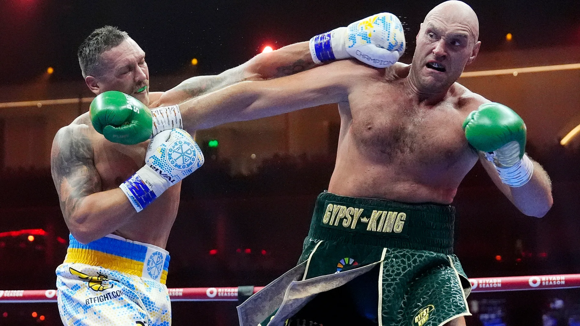 Britain’s Tyson Fury, right, and Ukraine’s Oleksandr Usyk exchange blows during their undisputed heavyweight world championship boxing fight at the Kingdom Arena in Riyadh, Saudi Arabia, Sunday, May 19, 2024. (Nick Potts/PA via AP)