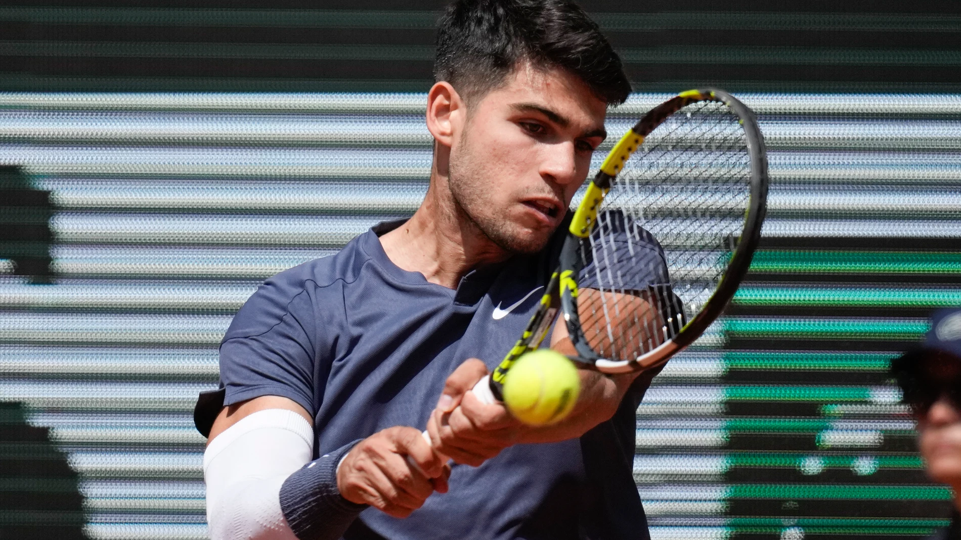 Spain's Carlos Alcaraz plays a shot against Jeffrey John Wolf of the U.S. during their first round match of the French Open tennis tournament at the Roland Garros stadium in Paris, Sunday, May 26, 2024. (AP Photo/Christophe Ena)