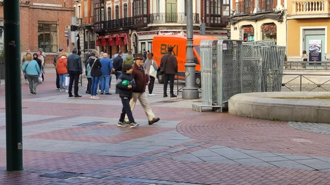 Gente paseando por la Plaza de España de Valladolid abrigados