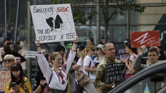 Ukrainians hold placards reading 'Captivity is killing!', 'Don't be silent!', 'Free Azov', among others, during a rally calling for authorities to return their relatives from Russian captivity, in downtown Kyiv, Ukraine.