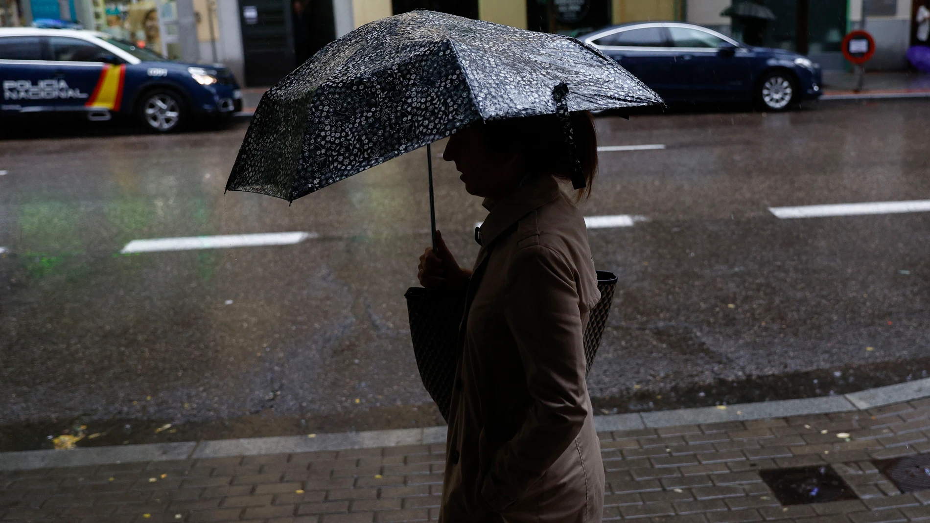MADRID, 10/06/2024.-Una mujer camina bajo la lluvia en Madrid este lunes. Una vaguada atlántica causará lluvias desde este lunes, provocando una inestabilidad generalizada que se prolongará hasta el miércoles. EFE/ Rodrigo Jiménez