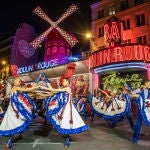 Open air French Can Can performance at the Moulin Rouge to celebrate the return of its windmill blades