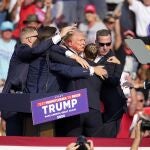 Republican presidential candidate former President Donald Trump is helped off the stage at a campaign event in Butler, Pa., Saturday, July 13, 2024