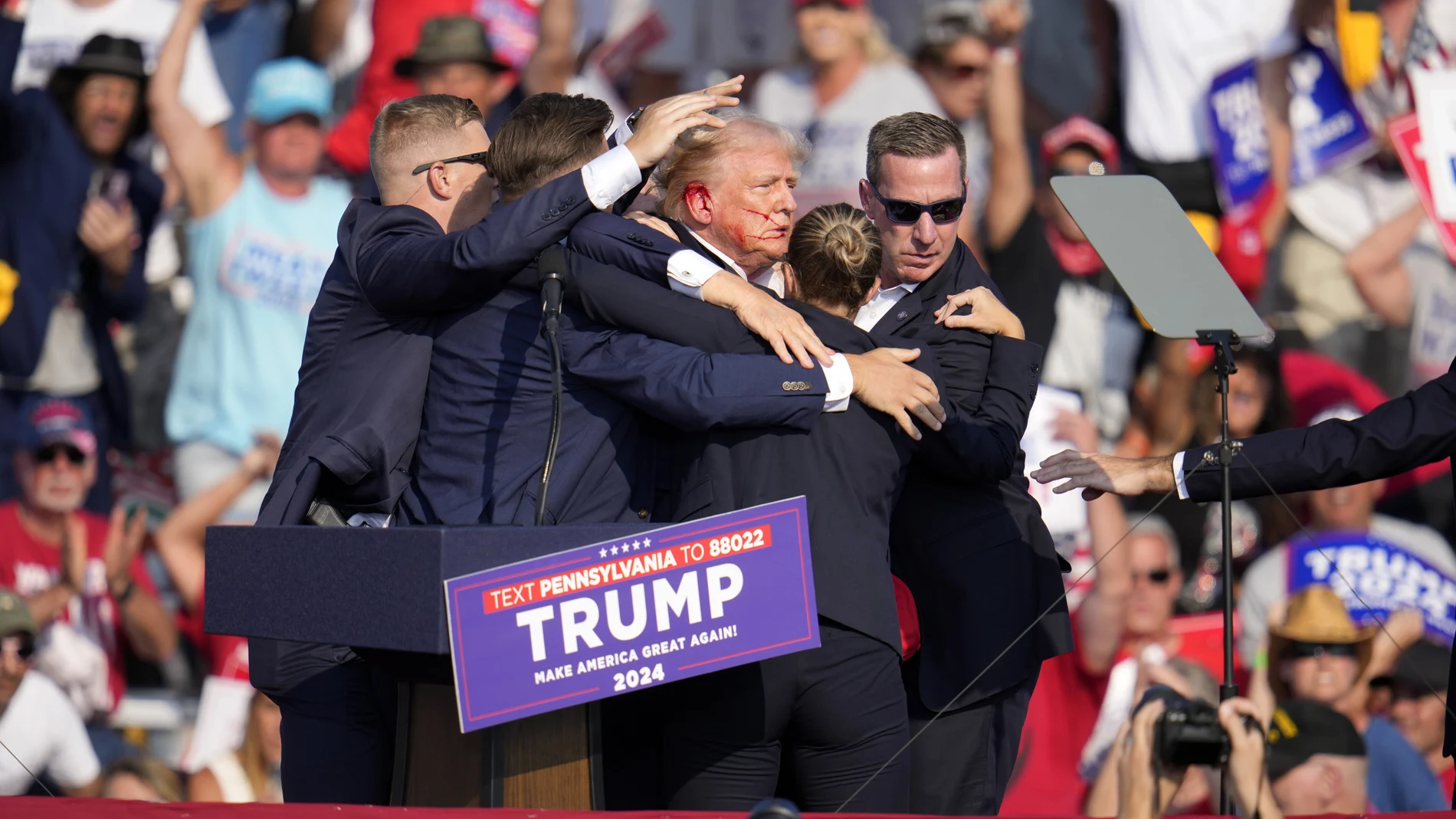 Republican presidential candidate former President Donald Trump is helped off the stage at a campaign event in Butler, Pa., Saturday, July 13, 2024