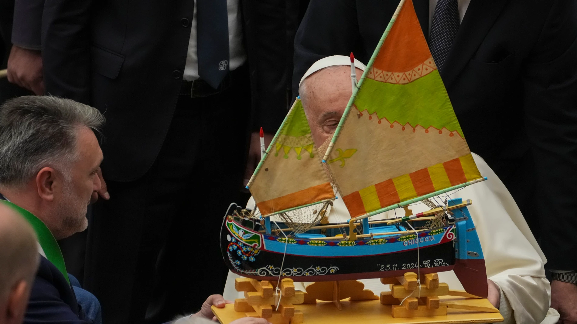 Pope Francis is presented with a model of a fishing boat during an audience with fishermen and members of the CEI, Italians Bishops Conference, in the Pope Paul VI hall at the Vatican, Saturday, Nov. 23, 2024. (AP Photo/Andrew Medichini)