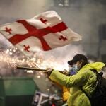 Georgian opposition supporters launch fireworks towards the police during a protest in front of the Parliament building in Tbilisi, Georgia, 30 November 2024. 