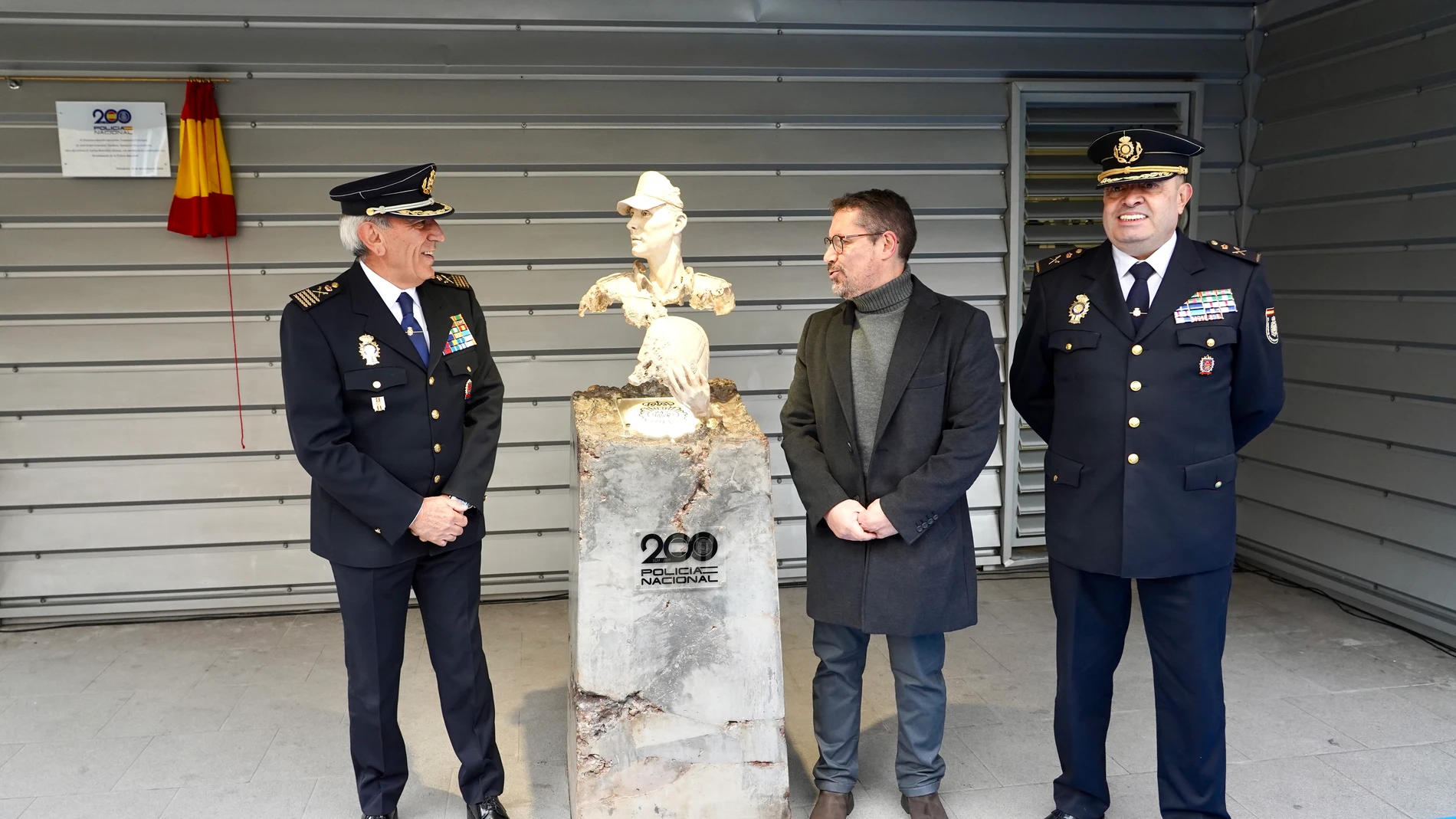 El jefe superior de la Policía Nacional en Castilla y León, Juan Carlos Hernández, yel director adjunto operativo de la Policía Nacional, José Ángel González, descubren la escultura junto a su autor, Carlos Retortillo