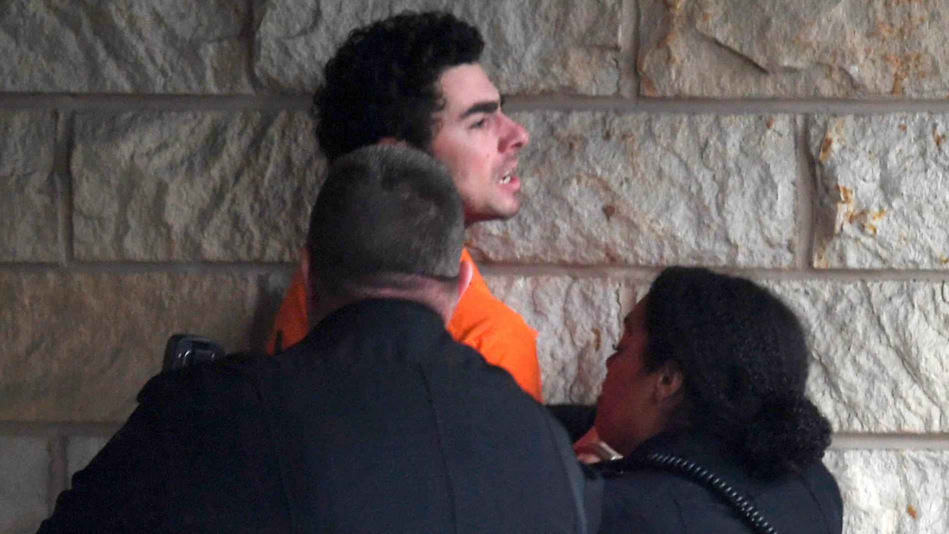 Luigi Nicholas Mangione is escorted into Blair County Courthouse, Tuesday, Dec. 10, 2024, in Hollidaysburg, Pa. (AP Photo/Gary M. Baranec)