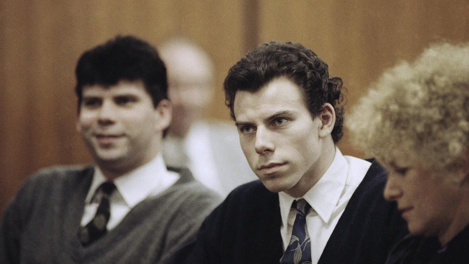 Lyle, left, and Erik Menendez sit with defense attorney Leslie Abramson, right, in the Municipal Court in the Beverly Hills area of Los Angeles, during a hearing, Nov. 26, 1990.