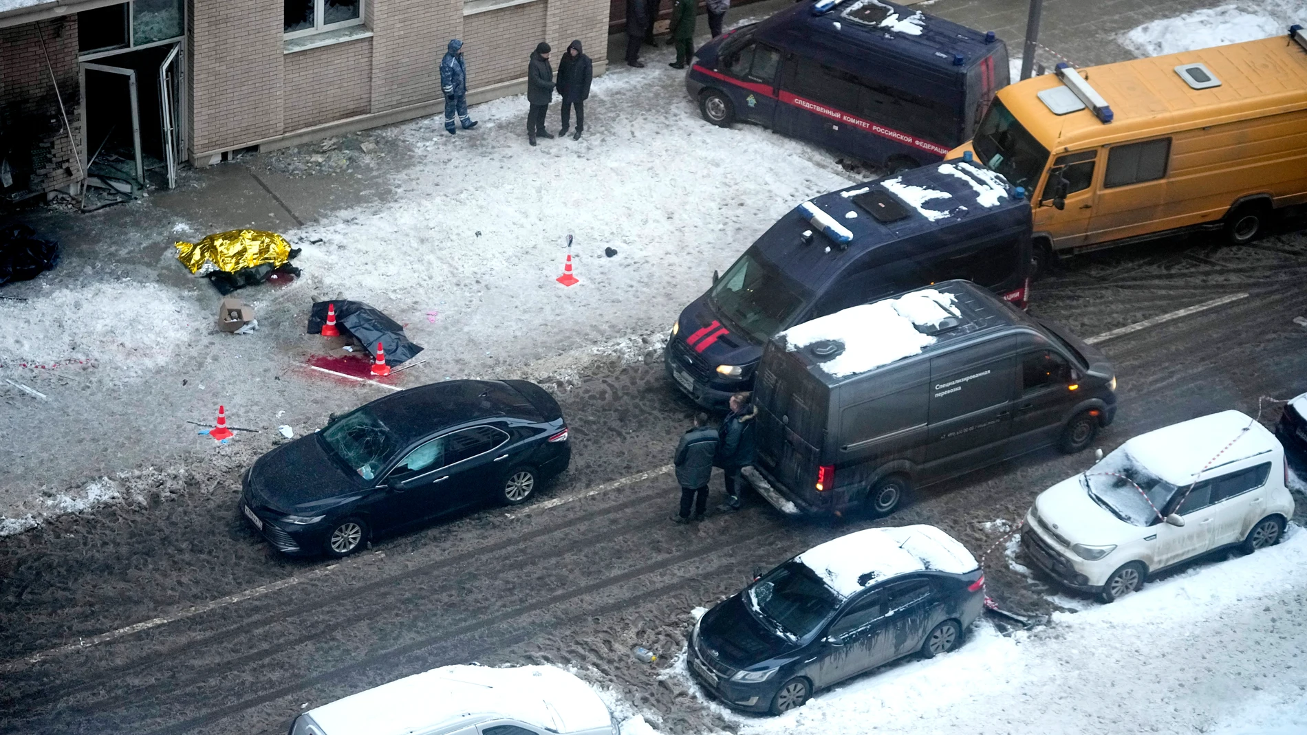 Investigators stand at the site where Lt. Gen. Igor Kirillov, the head of Russia's Nuclear, Biological, and Chemical Defense Forces, and his assistant, Ilya Polikarpov, were killed by an explosive device planted close to a residential apartment's block in Moscow, Russia, Tuesday, Dec. 17, 2024. (AP Photo)