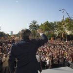 Catalan independence leader and former President Carles Puigdemont addresses supporters after his arrival near the Catalan parliament to attend the investiture debate in Barcelona, Spain