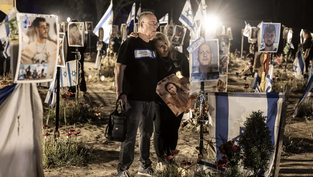 Relatives of victims of the October 7 attacks visit an installation bearing the photos of their loved ones who were killed or kidnapped during the attacks, at the site of the Nova festival, in Re'im, southern Israel
