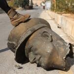 An opposition fighter steps on the decapitated statue of late Syrian President Hafez al-Assad in Mezzeh Military Airport in Damascus, Syria 12 December 2024. The Israeli army stated it has conducted airstrikes across Syria targeting strategic weapons stockpiles. Rebels ousted Syrian president Bashar al-Assad 08 December 2024. 