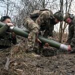 In the Donetsk region, Ukraine, on December 20, 2024, servicemen of Ukraine's Khyzhak Patrol Police Special Unit load a mortar while on a combat mission near Toretsk, Donetsk region, eastern Ukraine. (Photo by Ukrinform/NurPhoto) (Photo by Dmytro Smolienko / NurPhoto / NurPhoto via AFP)