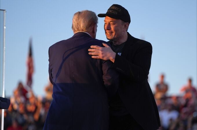 Republican presidential nominee former President Donald Trump hugs Elon Musk at a campaign rally at the Butler Farm Show, Saturday, Oct. 5, 2024, in Butler, Pa.