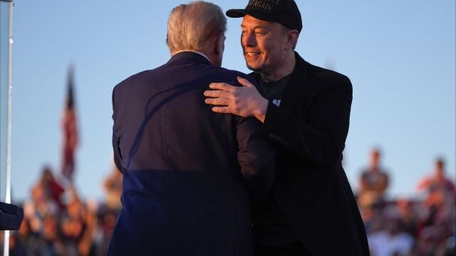 Republican presidential nominee former President Donald Trump hugs Elon Musk at a campaign rally at the Butler Farm Show, Saturday, Oct. 5, 2024, in Butler, Pa.