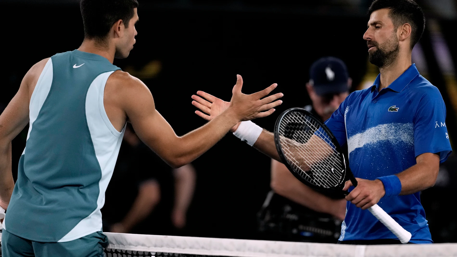 Novak Djokovic, right, of Serbia, is congratulated by Carlos Alcaraz of Spain following their quarterfinal match at the Australian Open tennis championship in Melbourne, Australia, early Wednesday, Jan. 22, 2025. (AP Photo/Ng Han Guan)