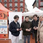 Irene Carvajal con tres d elos jóvenes participantes en el Rally, que han presentado los dos coches en la Plaza Mayor de Valladolid