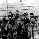  A picture taken just after the liberation by the Soviet army in January, 1945, shows a group of children wearing concentration camp uniforms behind barbed wire fencing in the Oswiecim (Auschwitz) nazi concentration camp.