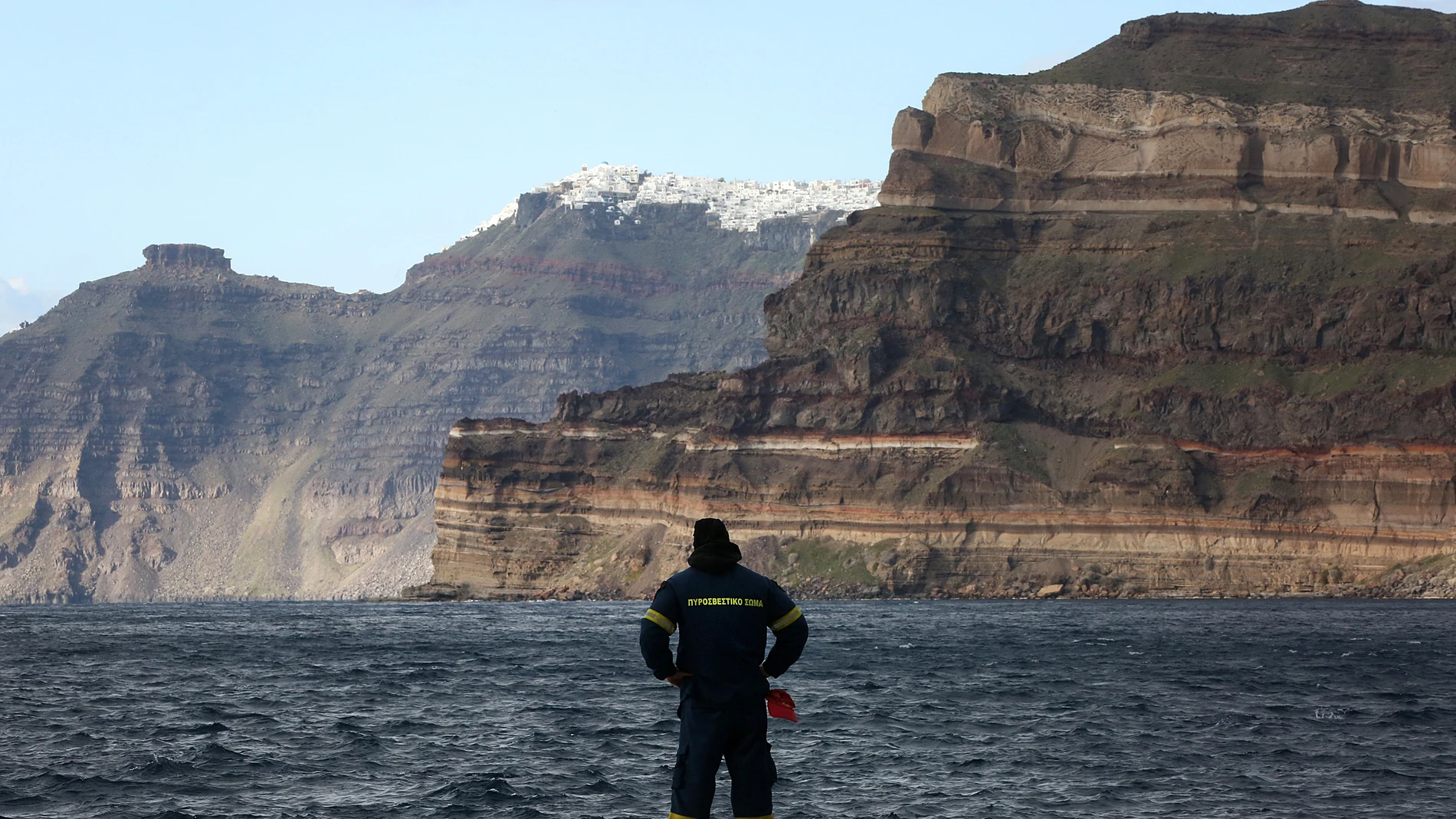 SANTORINI (Greece), 06/02/2025.- A firefighter from the Greek Fire and Rescue Service (EMAK) stands at the port of Santorini where a ship from the port of Piraeus is about to arrive, in Santorini, Greece, 06 February 2025. The municipality of Thera (Santorini) has declared a state of emergency due to a wave of seismic activity, taking effect from 01 February to 01 March. More than ten earthquakes of over 4.0 magnitude have jolted the region since the night of 04 February, with the strongest r...