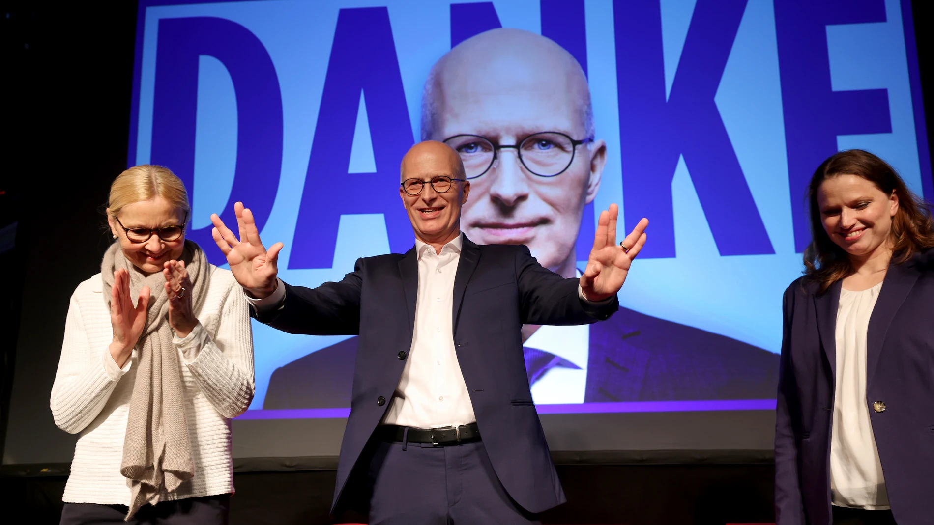 Peter Tschentscher, center, First Mayor of Hamburg and top candidate of the German Social Democratic party (SPD), attends the election party of the SPD in Hamburg, Germany, Sunday, March 2, 2025 following the state election in Hamburg. (Christian Charisius/dpa via AP)