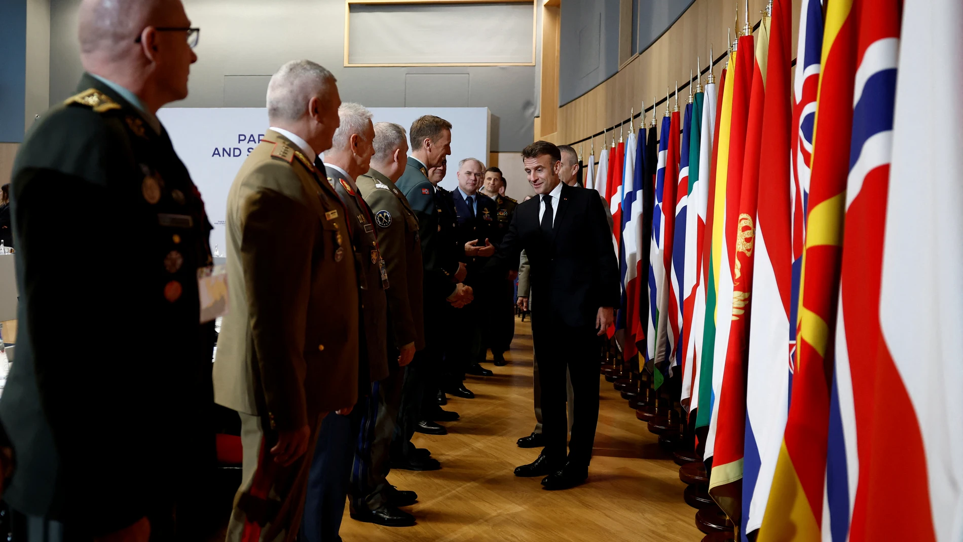 French President Emmanuel Macron, right, shakes hands with chiefs of staff of the European Union and NATO armies during a meeting on the conflict in Ukraine at the Musee de la Marine as part of the Paris Defense and Strategy Forum in Paris, Tuesday, March 11, 2025. (Sarah Meyssonnier/Pool via AP)