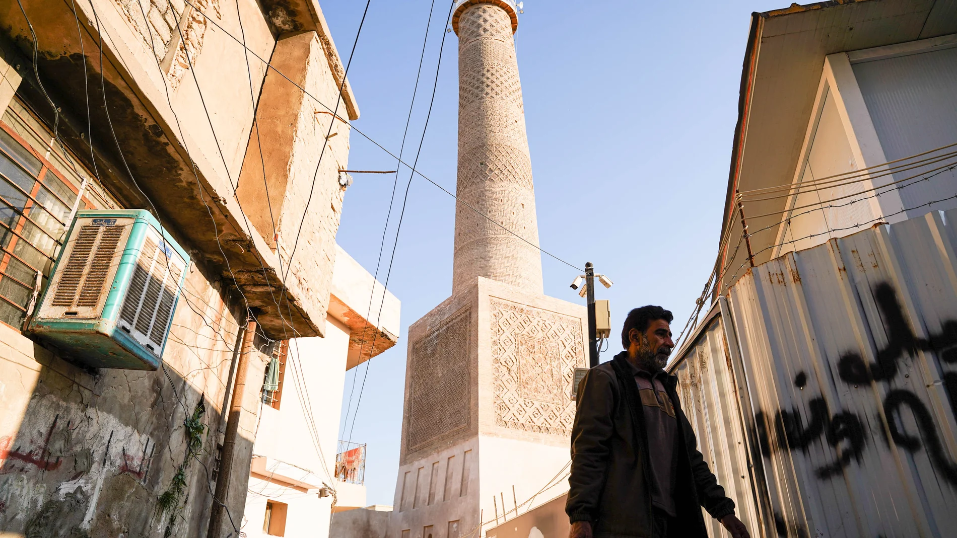 January 29, 2025, Mosul, Nineveh, Iraq: A man walks in front of the Al-Hadba minaret at the Great Mosque of al-Nuri, which was rebuilt after it was blown up by Islamic State militants. The Al-Hadba Minaret is one of the most prominent archaeological landmarks in the city of Mosul, which was blown up by ISIS during the battle to retake the city from the Islamic State (ISIS) on June 2017. UNESCO rebuilt the minaret which dates from the 12th century, using its old stones collected after the libe...