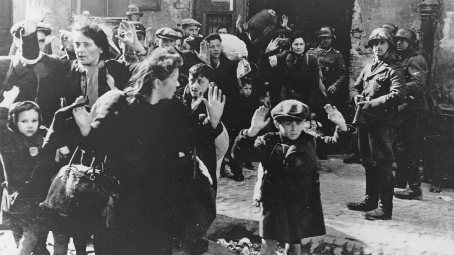 This Feb. 17, 1941 file photo shows a scene in the Warsaw Ghetto where Jews wearing white armlets bearing the Star of David board a tram marked with the words.