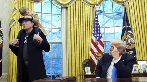 President Donald Trump listens as Elon Musk, joined by his son X Æ A-Xii, speaks in the Oval Office at the White House, Tuesday, Feb. 11, 2025, in Washington.