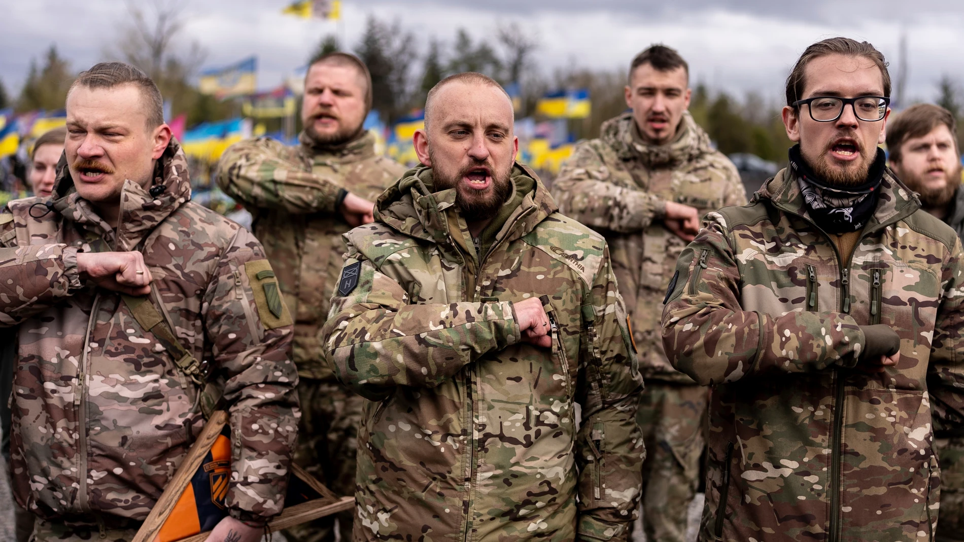 Brothers in arms of Marharyta Polovinko, 31, Ukrainian artist, paramedic and volunteer from 3rd Assault Brigade, who was killed recently on the frontline, pay their respect during the funeral ceremony in Krivyi Rih, Ukraine, Friday, April 11, 2025. (AP Photo/Alex Babenko)