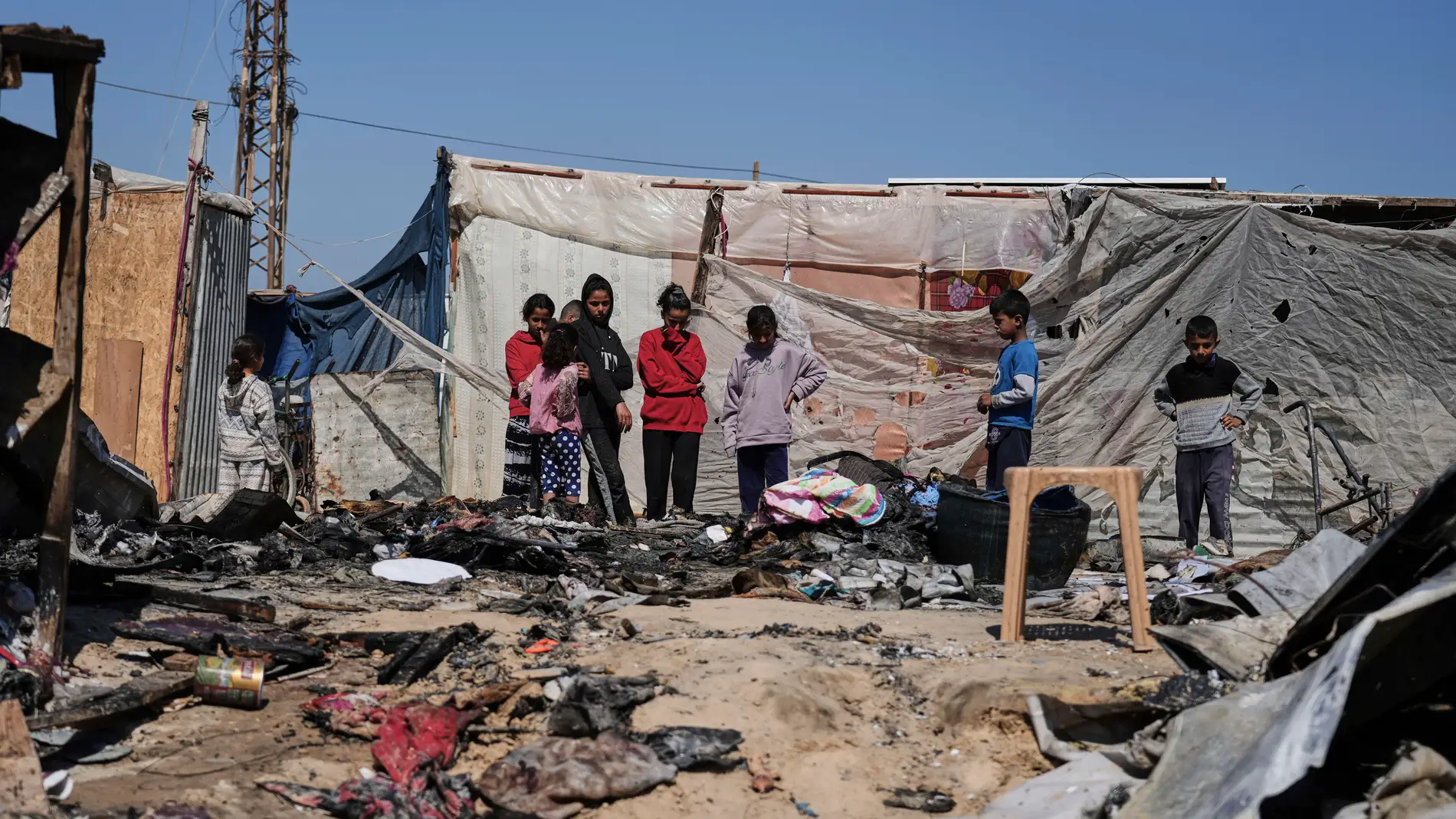 Palestinians inspect the remains of a displacement tent hit by an Israeli airstrike overnight, killing 10 members of the Abu Al-Rous family, in Khan Younis, southern Gaza Strip, Thursday, April 17, 2025. (AP Photo/Abdel Kareem Hana)