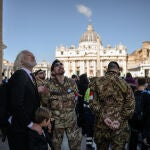 WikiLeaks founder Julian Assange (L) stands in Via della Conciliazione by St Peter's Square in The Vatican on April 26, 2025 during late Pope Francis' funeral ceremony.