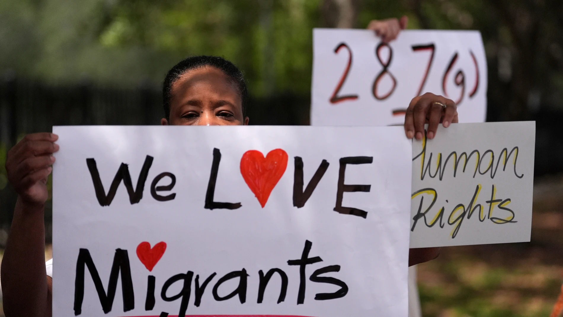 Advocates for migrant rights hold signs outside the South Florida office of U.S. Immigration and Customs Enforcement and Enforcement and Removal Operations, following a press conference with Gov. Ron DeSantis on immigration enforcement, Thursday, May 1, 2025, in Miramar, Fla. (AP Photo/Rebecca Blackwell)
