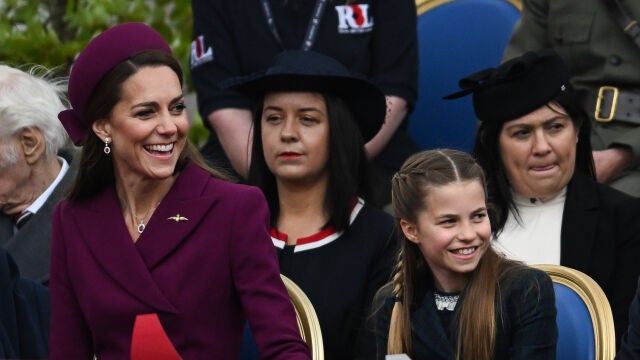 El look granate de Kate Middleton muy sonriente.