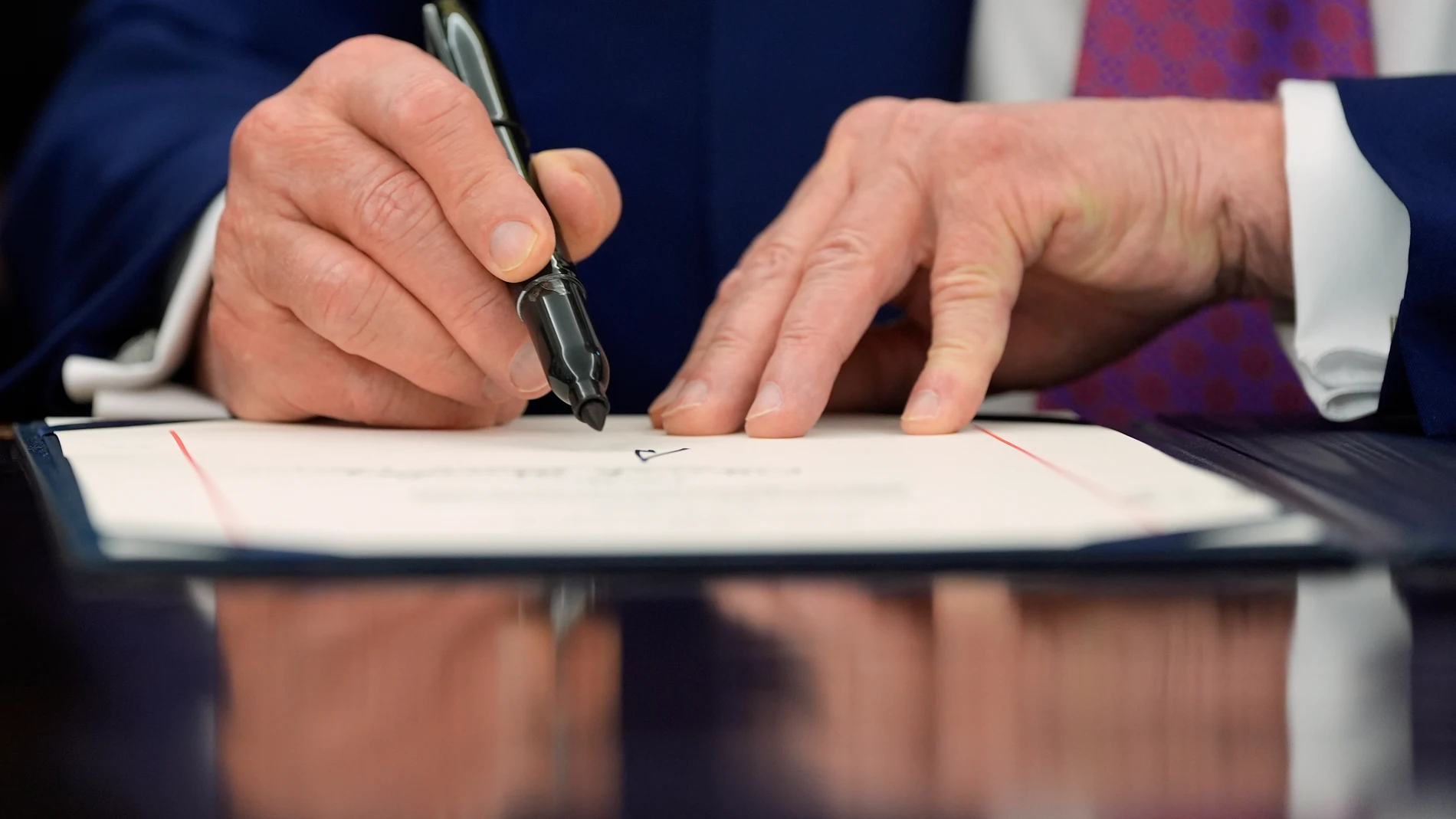 President Donald Trump signs a Congressional joint resolution in the Oval Office of the White House, Friday, May 9, 2025, in Washington. (AP Photo/Alex Brandon)