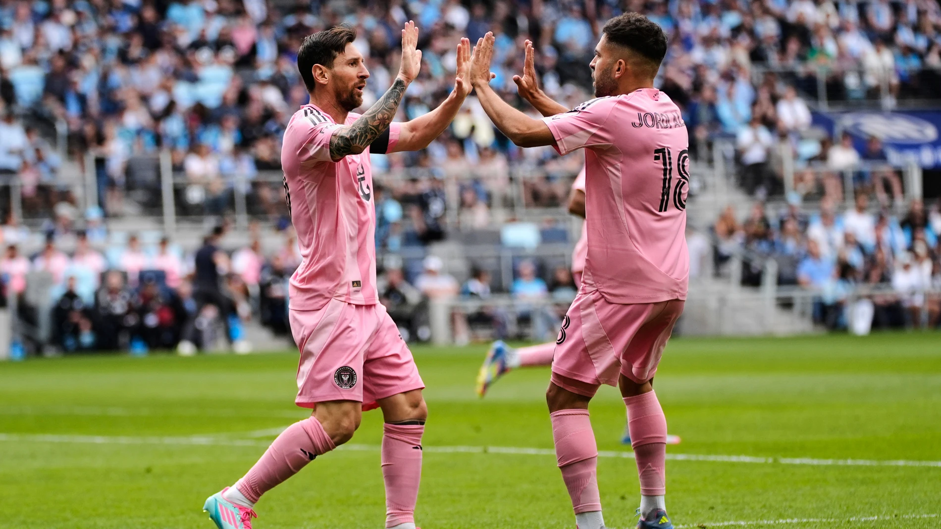 Inter Miami forward Lionel Messi, left, celebrates with defender Jordi Alba after scoring a goal during the second half of an MLS soccer match against Minnesota United, Saturday, May 10, 2025, in St. Paul, Minn. (AP Photo/Abbie Parr)