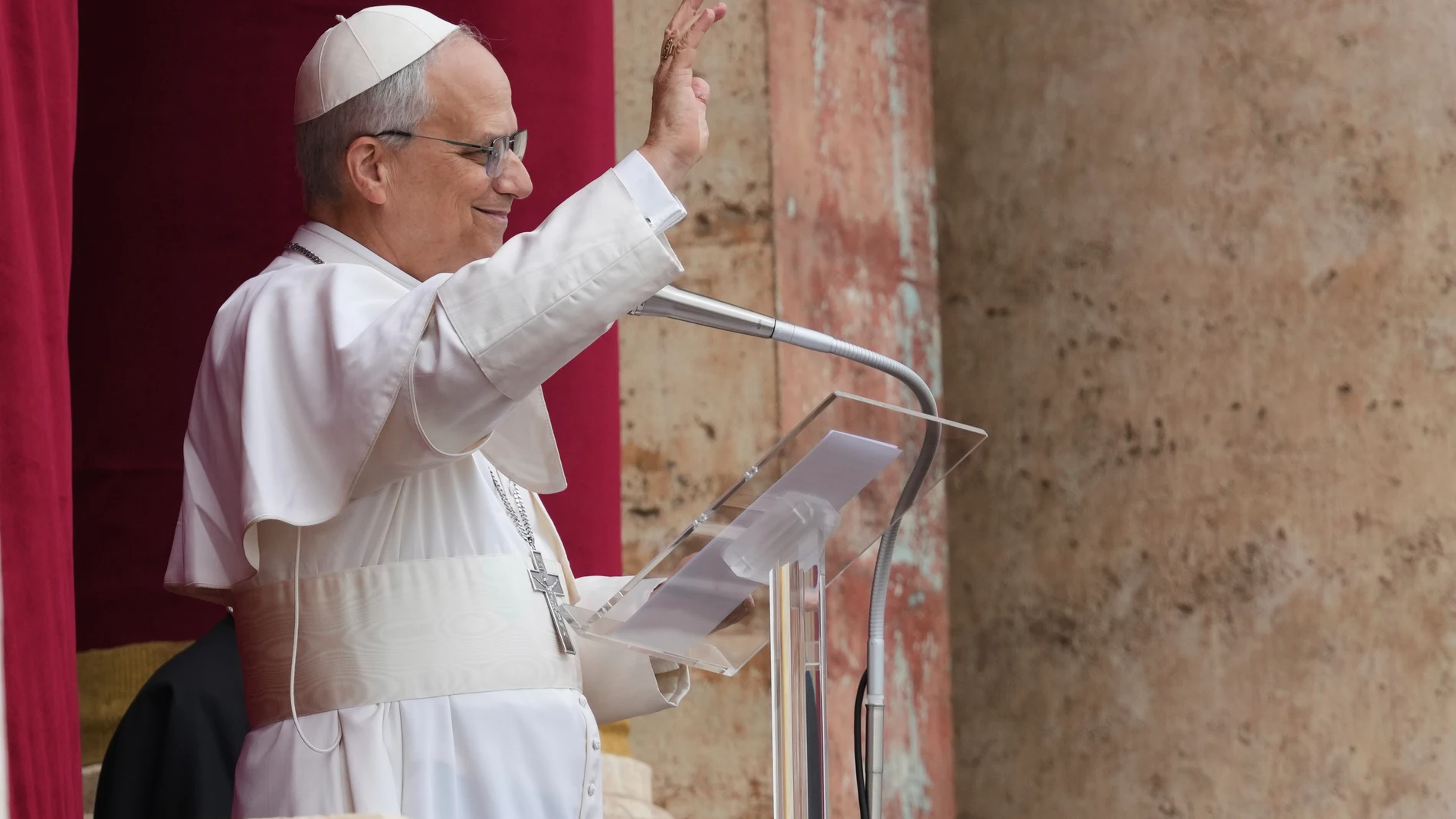 Pope Leo XIV appears at the central balcony of St. Peter's Basilica for his first Sunday blessing after his election, in St. Peter's Square at the Vatican, Sunday May 11, 2025. (AP Photo/Domenico Stinellis)
