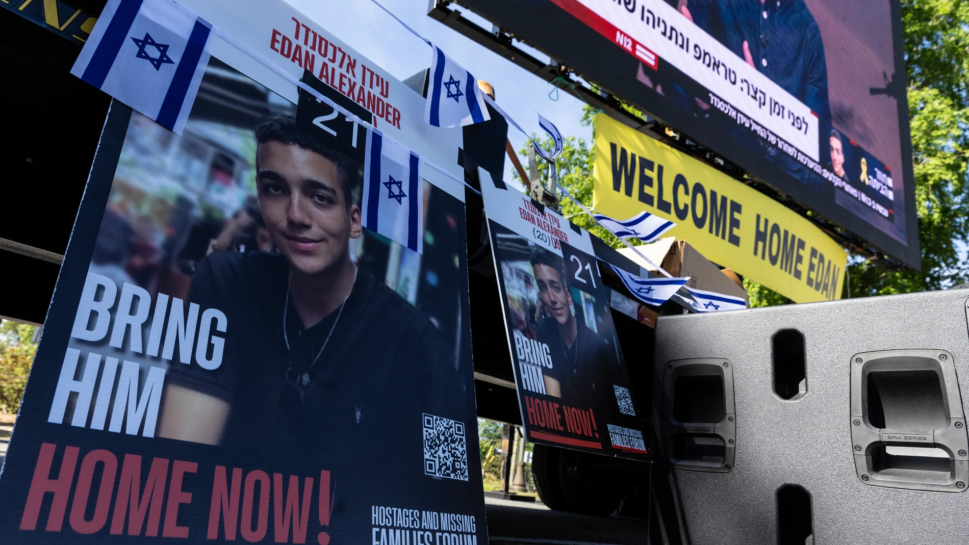 A poster of American hostage Edan Alexander is displayed in Huyler Park as residents and friends gather ahead of his release from Hamas on Monday, May 12, 2025 in Tenafly, N.J. (AP Photo/Stefan Jeremiah)