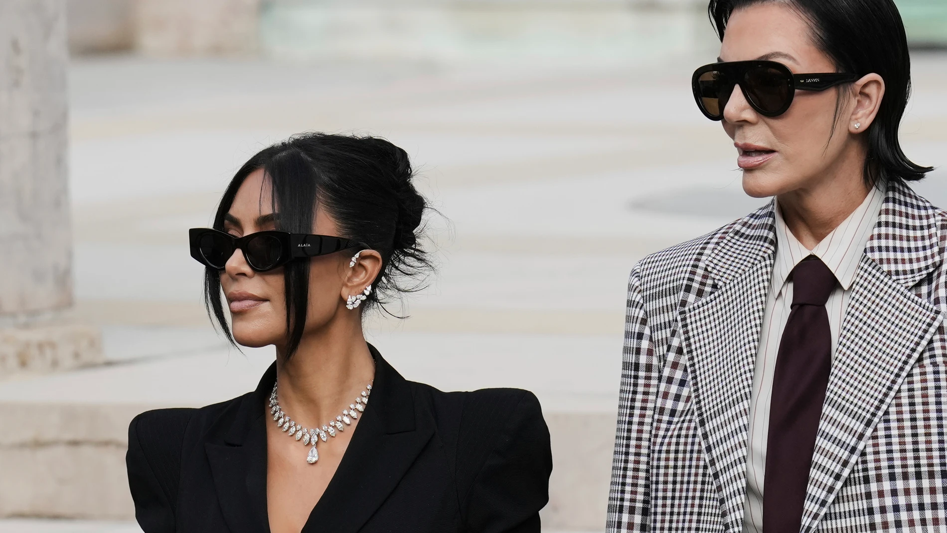 Kim Kardashian, left, accompanied by her mother Kris Jenner leaves the justice palace after testifying, regarding a robbery of millions of dollars in jewels from her Paris hotel room in 2016, in Paris, Tuesday, May 13, 2025. (AP Photo/Aurelien Morissard)