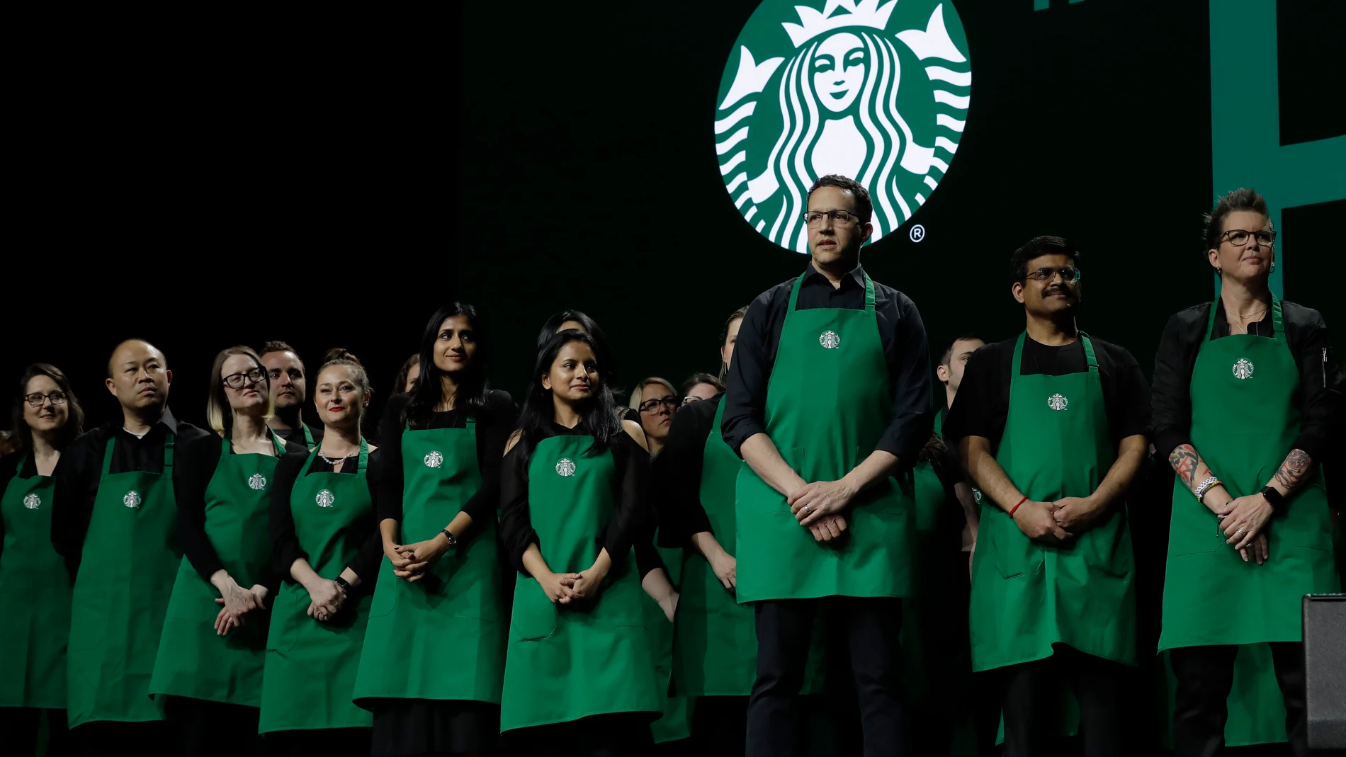 FILE - Starbucks baristas stand on stage, March 20, 2019, during an annual shareholders meeting in Seattle. (AP Photo/Ted S. Warren, file)